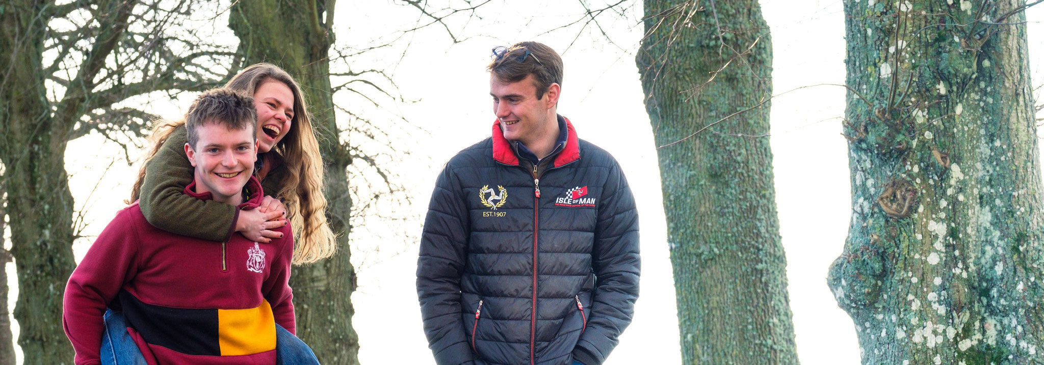 three students laughing in the outside