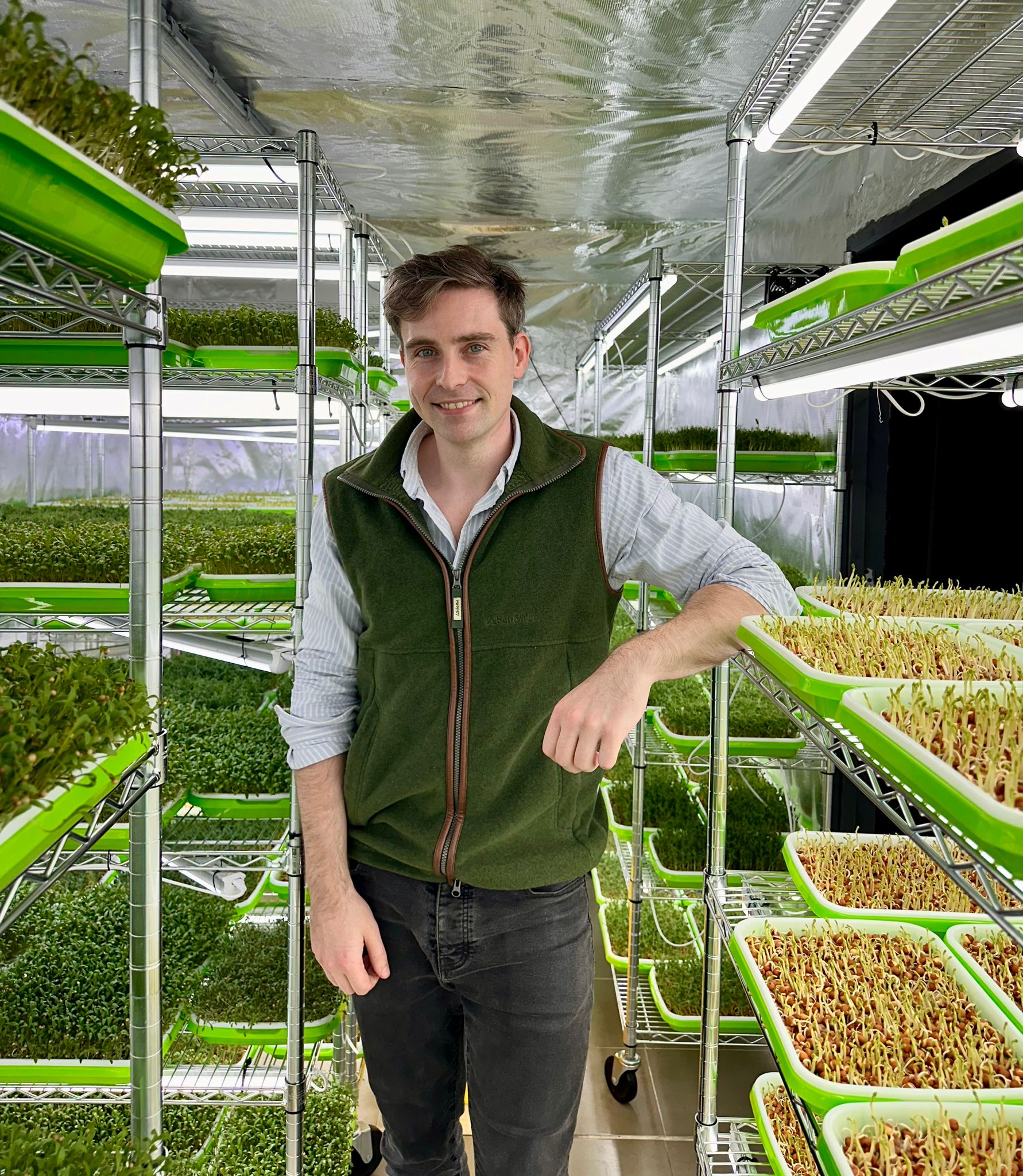 A graduate inside a crop growing room