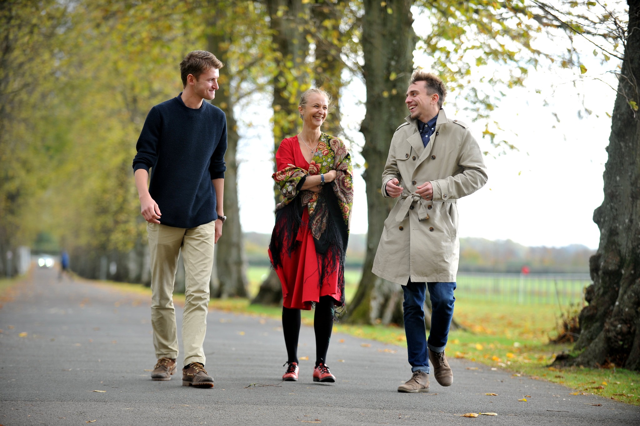 Three students walking on the driveway