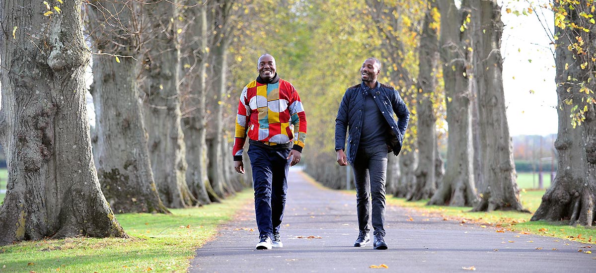 Two students walking down the driveway