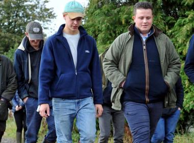 Students walking through a village