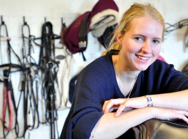 Equine student in tackroom